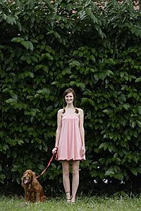 Mind Body Soul - Young woman standing with dog on leash