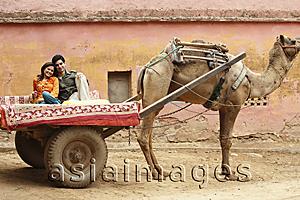 Asia Images Group - couple on camel cart