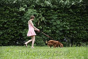 Mind Body Soul - Young woman walking dog