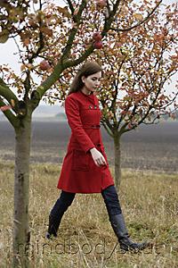Mind Body Soul - young woman walking through apple orchard