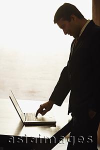 Asia Images Group - businessman working on laptop computer