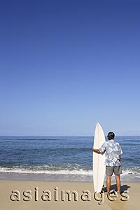 Asia Images Group - mature male surfer looking at sea