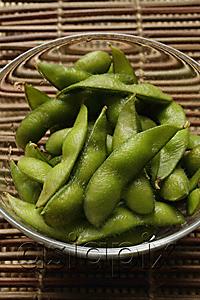 AsiaPix - green edamame beans in clear glass bowl