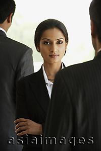 Asia Images Group - businesswoman surrounded by businessmen