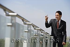Asia Images Group - businessman standing on balcony