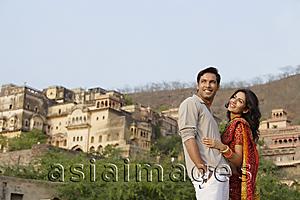 Asia Images Group - young couple standing with palace in background