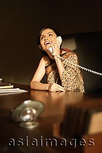 Asia Images Group - woman in sari on phone