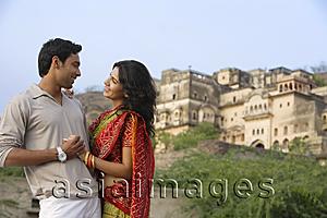 Asia Images Group - young couple embracing with palace in background