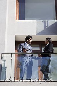 Asia Images Group - business associates speaking on balcony
