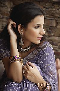 Asia Images Group - young woman in sari, hand on hair