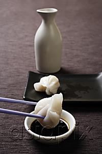 AsiaPix - chopstick dipping dim sum in soy sauce