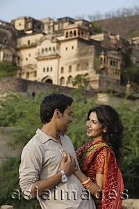 Asia Images Group - young couple embracing with palace in background