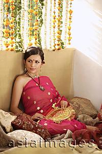 Asia Images Group - young woman relaxing, wearing sari and bindi