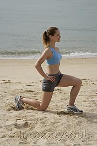 Mind Body Soul - woman stretching on beach