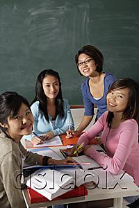 AsiaPix - Four young women studying together.