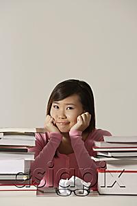 AsiaPix - young woman sitting at desk.
