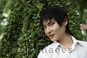 Asia Images Group - young man in front of tree
