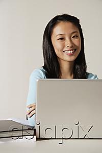 AsiaPix - young woman working at laptop.