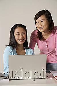 AsiaPix - Two women at laptop, smiling.