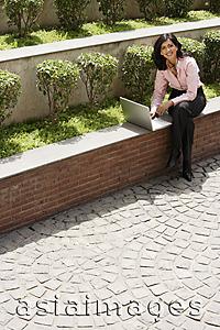 Asia Images Group - businesswoman working outside on laptop