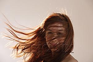 AsiaPix - Young Asian girl with hair blowing in the wind.