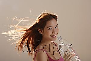 AsiaPix - Asian girl holding bottle water with hair blowing