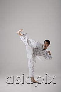 AsiaPix - Man kicking high in the air, martial arts
