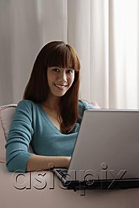 AsiaPix - Asian girl working on laptop at home