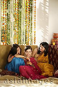 Asia Images Group - three young women wearing saris