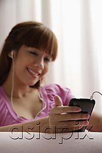 AsiaPix - Asian girl reading listening to music