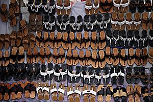 AsiaPix - Many leather sandals on display at market.