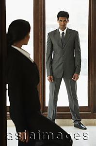 Asia Images Group - Businesswoman looking at businessman