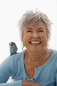 Mind Body Soul - Older woman with blue bird on her shoulder.