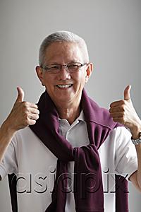AsiaPix - mature man with grey hair holding thumbs up and smiling