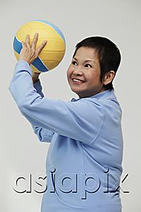 AsiaPix - Mature woman throwing a volleyball