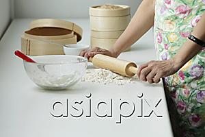 AsiaPix - Cropped shot of Chinese woman cooking