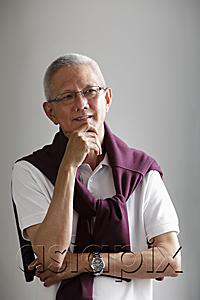 AsiaPix - head shot of mature man with grey hair thinking