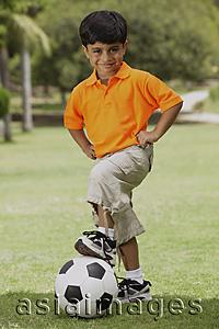 Asia Images Group - little boy with foot on soccer ball