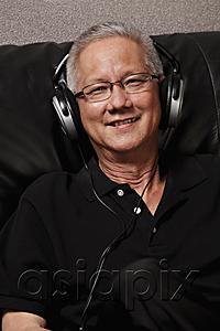 AsiaPix - mature man with grey hair wearing head phones and smiling
