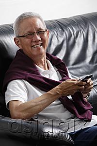 AsiaPix - mature man with grey hair smiling holding a phone