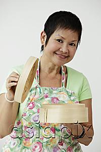 AsiaPix - Mature Chinese woman holding bamboo steamer