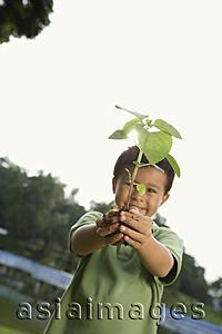 Asia Images Group - Boy holding plant and soil