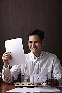AsiaPix - Man sitting at desk smiling at paper