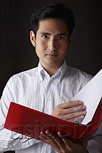 AsiaPix - head shot of man holding folder