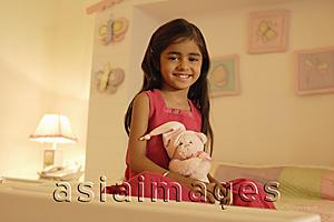 Asia Images Group - little girl on bed with teddy bear