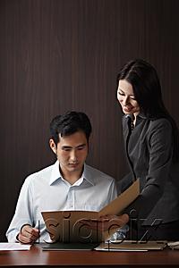AsiaPix - Man and woman looking at folder