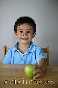 Asia Images Group - Little boy holding green apple