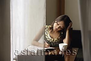 Asia Images Group - woman with notebook, cup of coffee