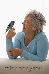 Mind Body Soul - Older woman holding blue bird.
