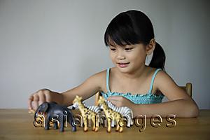 Asia Images Group - Little girl playing with animals